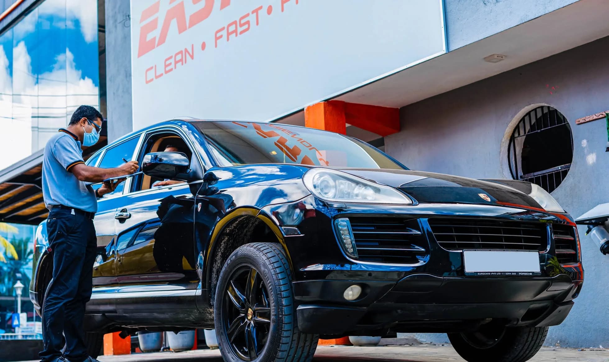 EasyCare team member checking in a customer's vehicle outside the EasyCare facility
