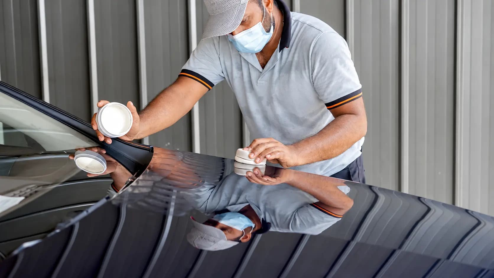 EasyCare technician applying wax to a vehicle bonnet